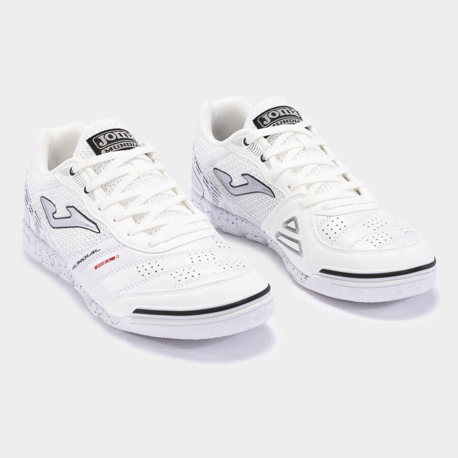 JOMA Mundial futsal trainers in white, angled pair showing breathable mesh and sleek design.